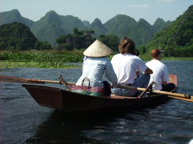 paddling up the
      river near Hanoi